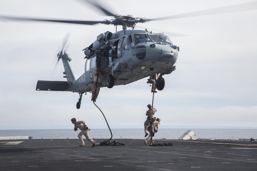 U.S. Marines with Fox Company, 2nd Battalion, 1st Marine Regiment and the Maritime Raid Force with the 13th Marine Expeditionary Unit, fast rope from a CH-60 Seahawk with Helicopter Sea Combat Squadron 23 aboard the USS Boxer off the coast of southern California during their Sustainment Exercise Jan. 17, 2016. SUSTEX is designed to reinforce the Boxer Amphibious Ready Group/MEU's execution of mission essential tasks in preparation for their upcoming deployment. (U.S. Marine Corps photo by Sgt. Tyler C. Gregory/released)