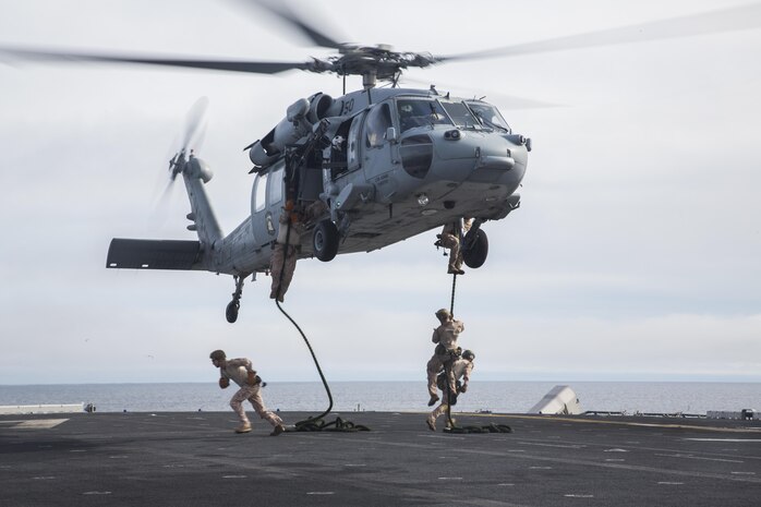 U.S. Marines with Fox Company, 2nd Battalion, 1st Marine Regiment and the Maritime Raid Force with the 13th Marine Expeditionary Unit, fast rope from a CH-60 Seahawk with Helicopter Sea Combat Squadron 23 aboard the USS Boxer off the coast of southern California during their Sustainment Exercise Jan. 17, 2016. SUSTEX is designed to reinforce the Boxer Amphibious Ready Group/MEU's execution of mission essential tasks in preparation for their upcoming deployment. (U.S. Marine Corps photo by Sgt. Tyler C. Gregory/released)