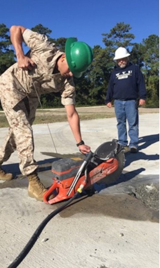 On October 20 2015, Second Lieutenant David A. Calderon, a Marine attached to Combat Engineer Officer course 1-16 (CEO 1-16); learns how to start and operate the concrete saw as part of the Airfield Damage Repair class taught by Mr. Frank Miller, standing by as a safety supervisor; at Marine Corps Engineer School, Courthouse Bay, Camp Lejeune, N.C.

