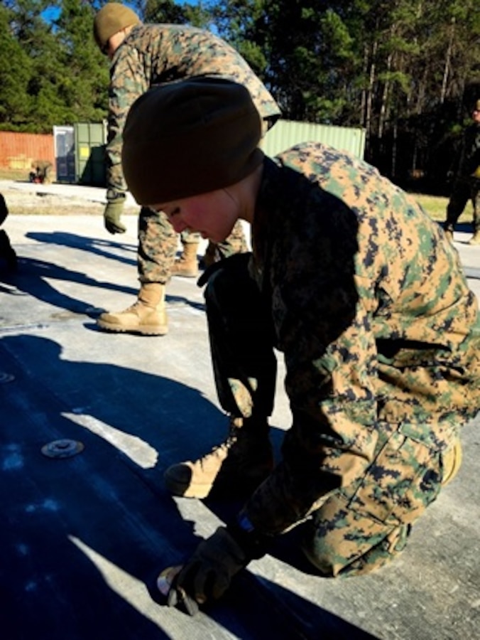 On January 19 2016, Second Lieutenant Morgan Oswald, a Marine attached to Combat Engineer Officer course 3-16 (CEO 3-16); conducts a practical application on airfield damage repair by attaching two fiberglass reinforced panels using bolts. These panels are used for temporary repairs on airfields and one set can cover a 25 foot diameter crater. 
