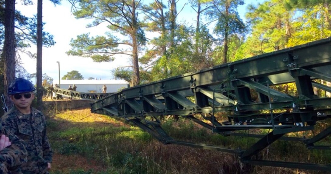 On November 18, 2015 Second Lieutenant David Swensen, a Marine attached to Combat Engineer Officer course 2-16 (CEO 2-16);  observes Marines from 8th and 9th Engineer Support Battalions install a double story Medium Girder Bridge (MGB) with link reinforcement across a wet gap aboard at Marine Corps Engineer School, Courthouse Bay Camp Lejeune, N.C. 

