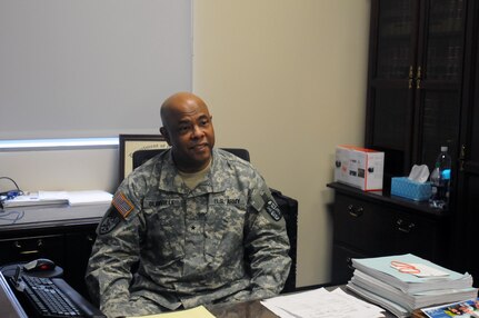 Brigadier General Glanville sits and listens to a fellow judge as he takes a break from trial work. BG Glanville is a Superior Court Judge in Fulton County, GA.