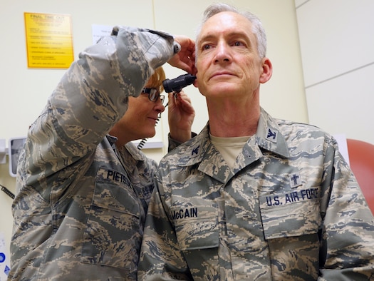 Air Force Col. (Dr.) Kimberly Pietszak, interim chief, Department of Quality Services, and assistant chief, Department of Medicine, examines Air Force Col. Patrick McCain at San Antonio Military Medical Center, Aug 26, 2015.  Getting regular checkups are vital step in maintaining one’s Individual Medical Readiness and aids an Airman’s ability to support the mission. (U.S. Air Force photo by Corey Toye)