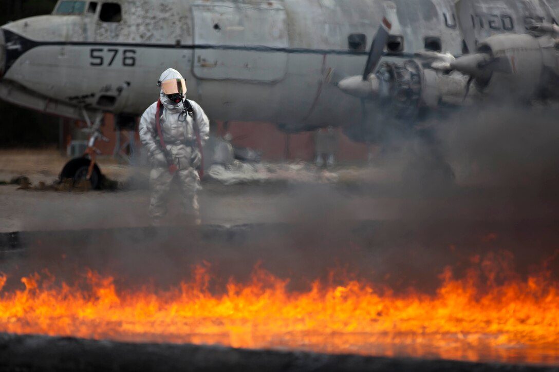 A Marine observes other Marines conducting firefighting training at Marine Corps Air Station Cherry Point, N.C., Jan. 20, 2016. U.S. Marine Corps photo by Cpl. Stephanie Cervantes