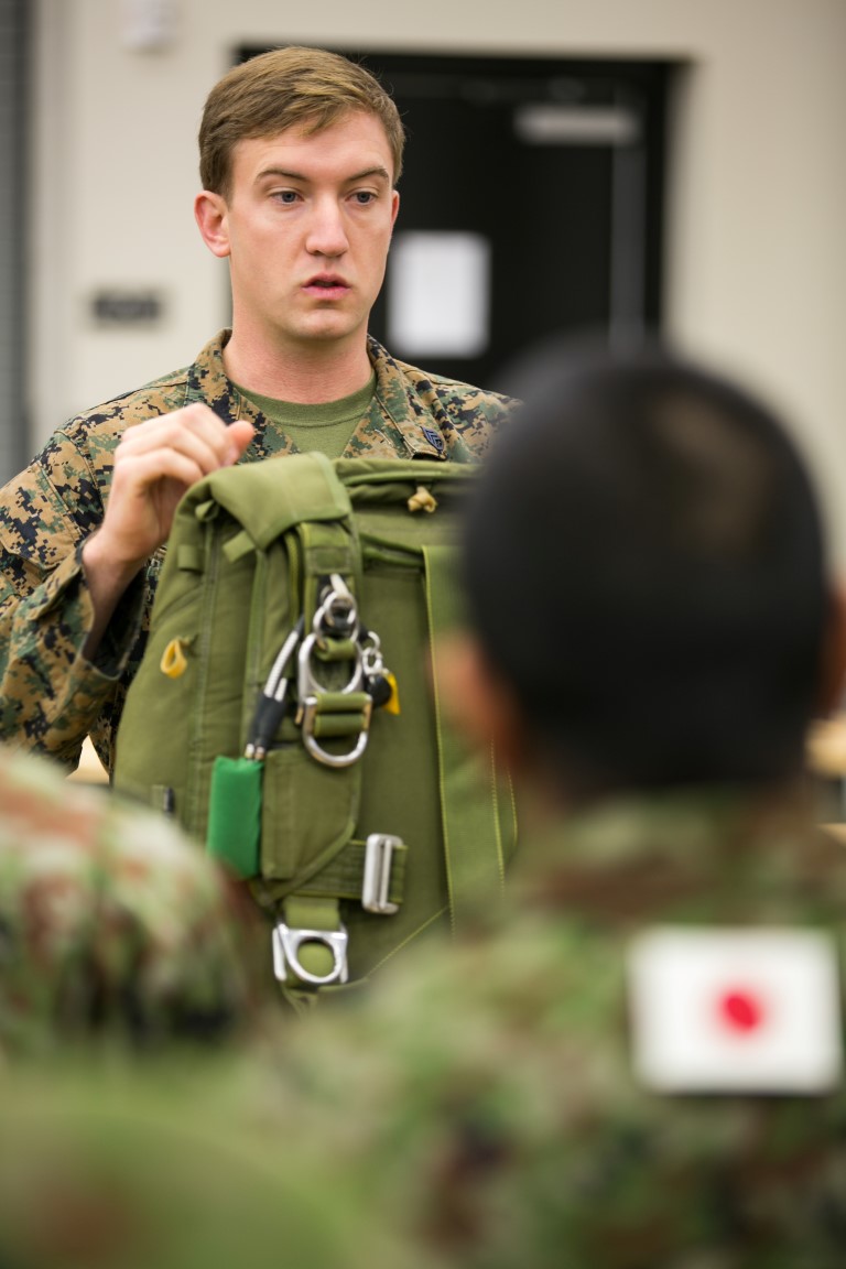 Staff Sgt. Mark Pins, a reconnaissance man with 1st Recon Bn., 1st Marine Division, instructs Japan Ground Self-Defense Force soldiers on proper usage and deployment of the multi-mission parachute system (MMPS), which is used to conduct free fall operations during Exercise Iron Fist 2016 aboard Camp Pendleton, Calif., Jan. 25, 2016. Iron Fist is an annual bilateral amphibious training exercise held in Southern California between the United States Marine Corps and Japan Ground Self-Defense Force.