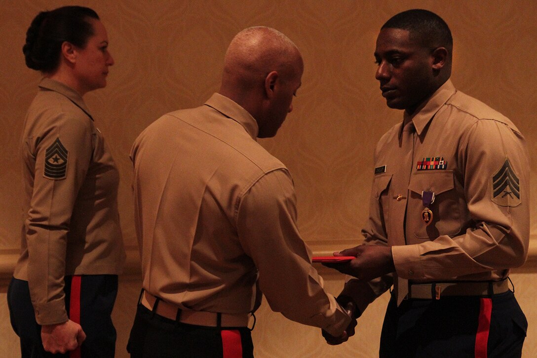 Sgt. DeMonte R. Cheeley is presented the Purple Heart medal by Brig. Gen. Terry V. Williams Jan. 26, 2015, at a ceremony in Chattanooga, Tenn. Cheeley received the Purple Heart for injuries he sustained during a July 16, 2015 attack in Chattanooga at the Armed Forces Career Center where he works. An investigation conducted by the FBI and the Naval Criminal Investigative Service determined the attack had been inspired by a foreign terrorist group making Cheeley eligible for the Purple Heart. Cheeley is a Recruiting Substation Chattanooga recruiter in Chattanooga, Tenn. Williams is the Commanding General of Marine Corps Recruit Depot Parris Island and Eastern Recruiting Region. (Official Marine Corps photo by Cpl. Diamond N. Peden/Released)