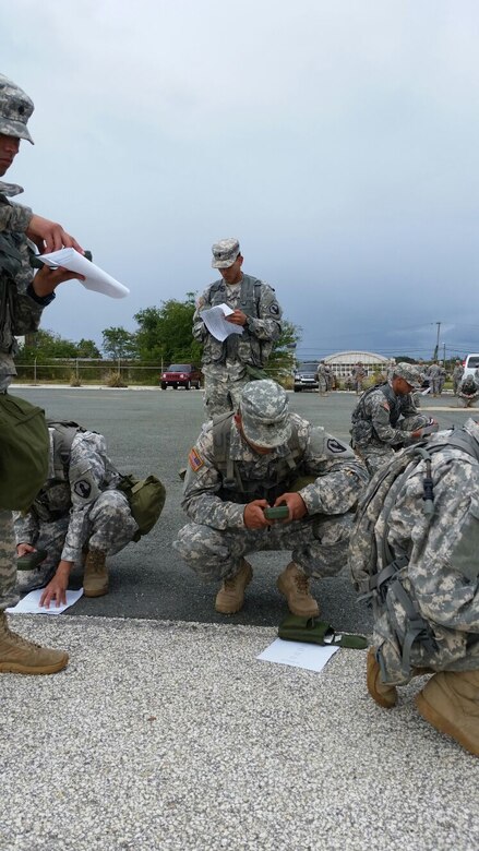 Competitors input grid coordinates into their DAGRs before beginning the land navigation event of the 77th CSSB Best Warrior Competition held 22-24 January at Ramey Base, Aguadilla, Puerto Rico.