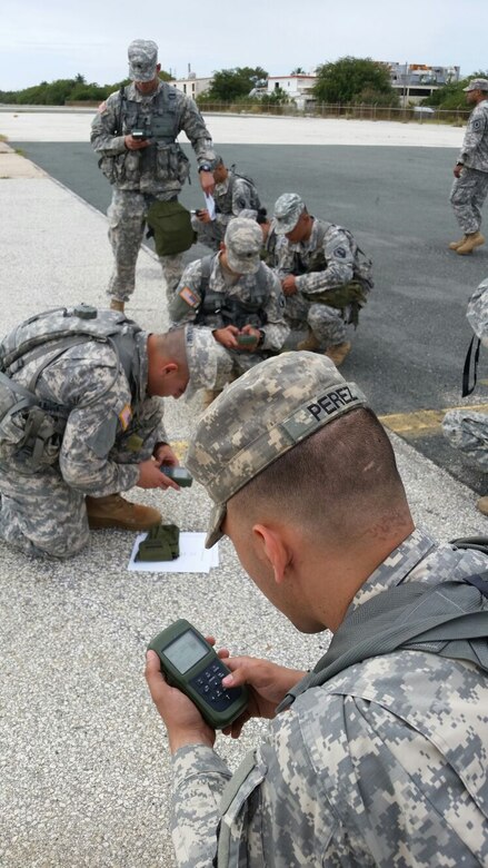 Competitors input grid coordinates into their DAGRs before beginning the land navigation event of the 77th CSSB Best Warrior Competition held 22-24 January at Ramey Base, Aguadilla, Puerto Rico.