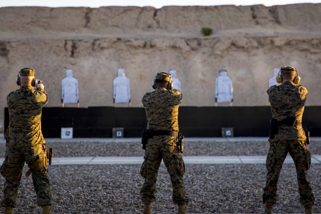 Marines aim downrange during firearms training and qualification at the pistol range on Marine Corps Air Station Yuma, Ariz., Jan. 20, 2016. U.S. Marine Corps photo by Cpl. Reba James