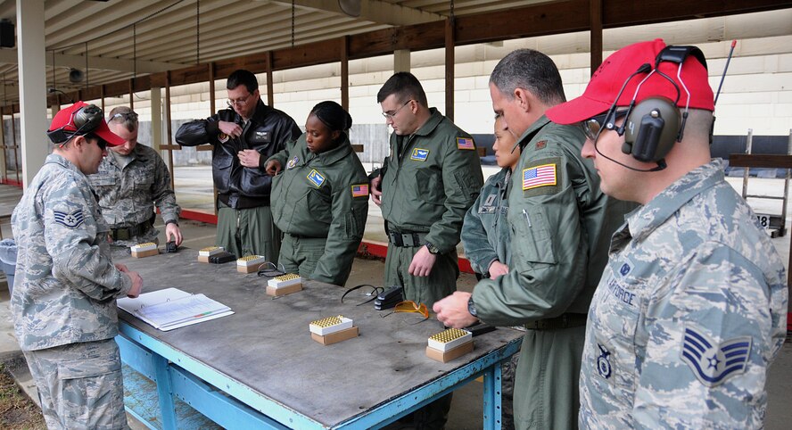 94th Airlift Wing combat arms instructors brief Airmen on the small-arms qualification process Jan. 9, 2015 at Dobbins Air Reserve Base, Ga. The qualifiers consisted of Airmen of various units around Dobbins. (U.S. Air Force photo/ Senior Airman Andrew J. Park)