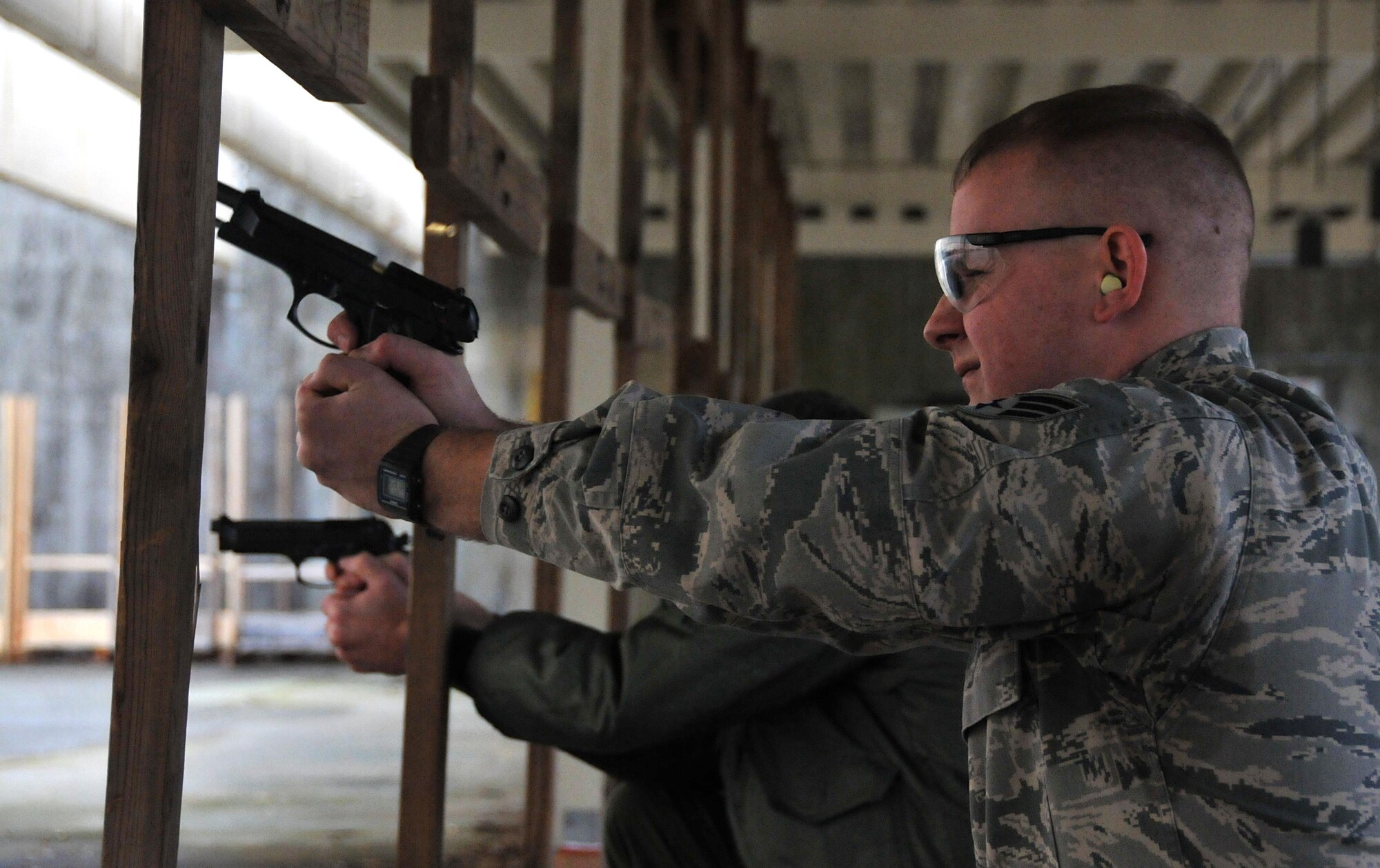 Senior Airman James Trotter, 94th Aeromedical Evacuation Squadron simulation and training technician, fires a shot at a target at the shooting range Jan. 9, 2015 at Dobbins Air Reserve Base, Ga. Prior to the qualification course, qualifiers were taught to identify their dominant eye as it provides 80 percent of a person’s depth perception. (U.S. Air Force photo/ Senior Airman Andrew J. Park)