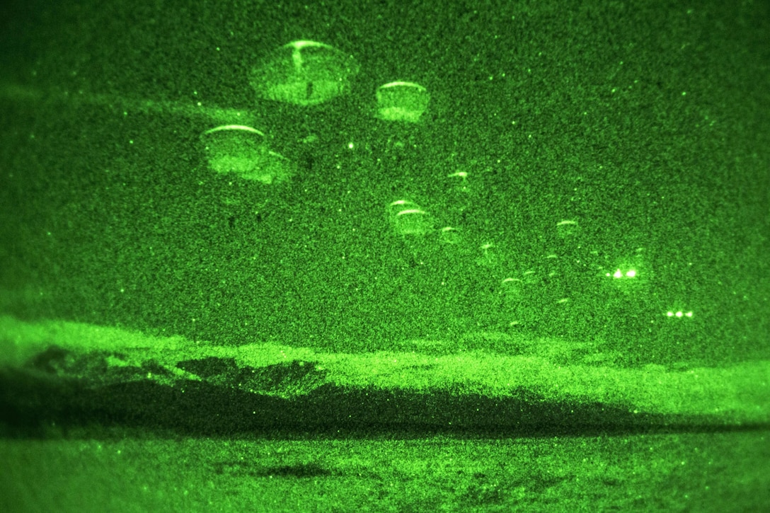 As seen through a night-vision device, paratroopers participate in a night jump onto Malemute drop zone on Joint Base Elmendorf-Richardson, Alaska, Jan. 21, 2016. U.S. Air Force photo by Alejandro Pena