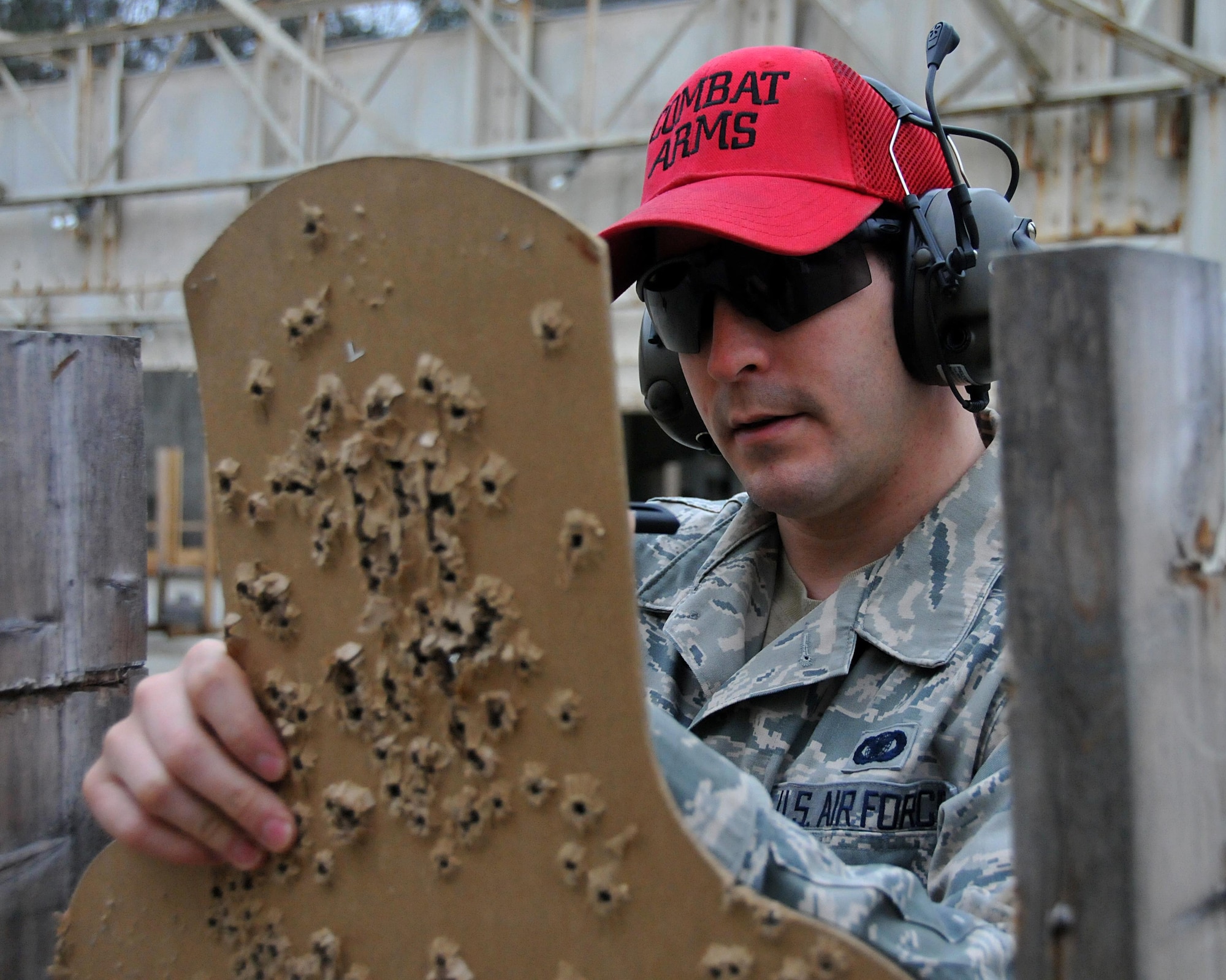 Staff Sgt. Warren Powell, 94th Airlift Wing combat arms instructor, scores a target during a small arms qualification process Jan. 9, 2015 at Dobbins Air Reserve Base, Ga. To qualify, shooters must have 35 shots hit the green area of the target. (U.S. Air Force photo/ Senior Airman Andrew J. Park)