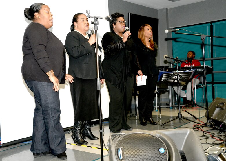 The Huntsville Center Ensemble, from left, Tina Maye, Angela Morton, Lillian Fox and Reneda Kelly sing gospel music during the Dr. Martin Luther King Jr. Unity Day Celebration Jan. 22, as Elder Dwight Clark, an associate minister and minister of music at the Douglas Tabernacle Primitive Baptist Church, Huntsville, Alabama, accompanies them on the keyboard.