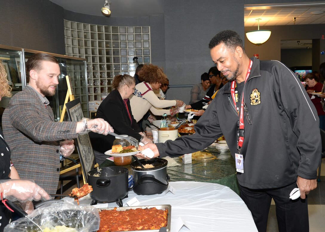 Tyler Yell, a student in Installation Support and Programs Management, serves a variety of food to U.S. Army Engineering and Support Center, Huntsville employees during the Dr. Martin Luther King Jr. Unity Day Celebration Jan. 22. 