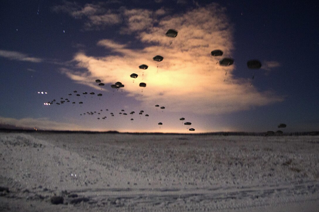 U.S. and Canadian paratroopers take part in a night jump over Malemute drop zone on Joint Base Elmendorf-Richardson, Alaska, Jan. 21, 2016. The paratroopers are assigned to the 25th Infantry Division’s 4th Brigade Combat Team, Airborne, Alaska, and Canadian paratroopers are assigned to the Princess Patricia's Canadian Light Infantry Regiment. U.S. Air Force photo by Staff Sgt. Sheila deVera