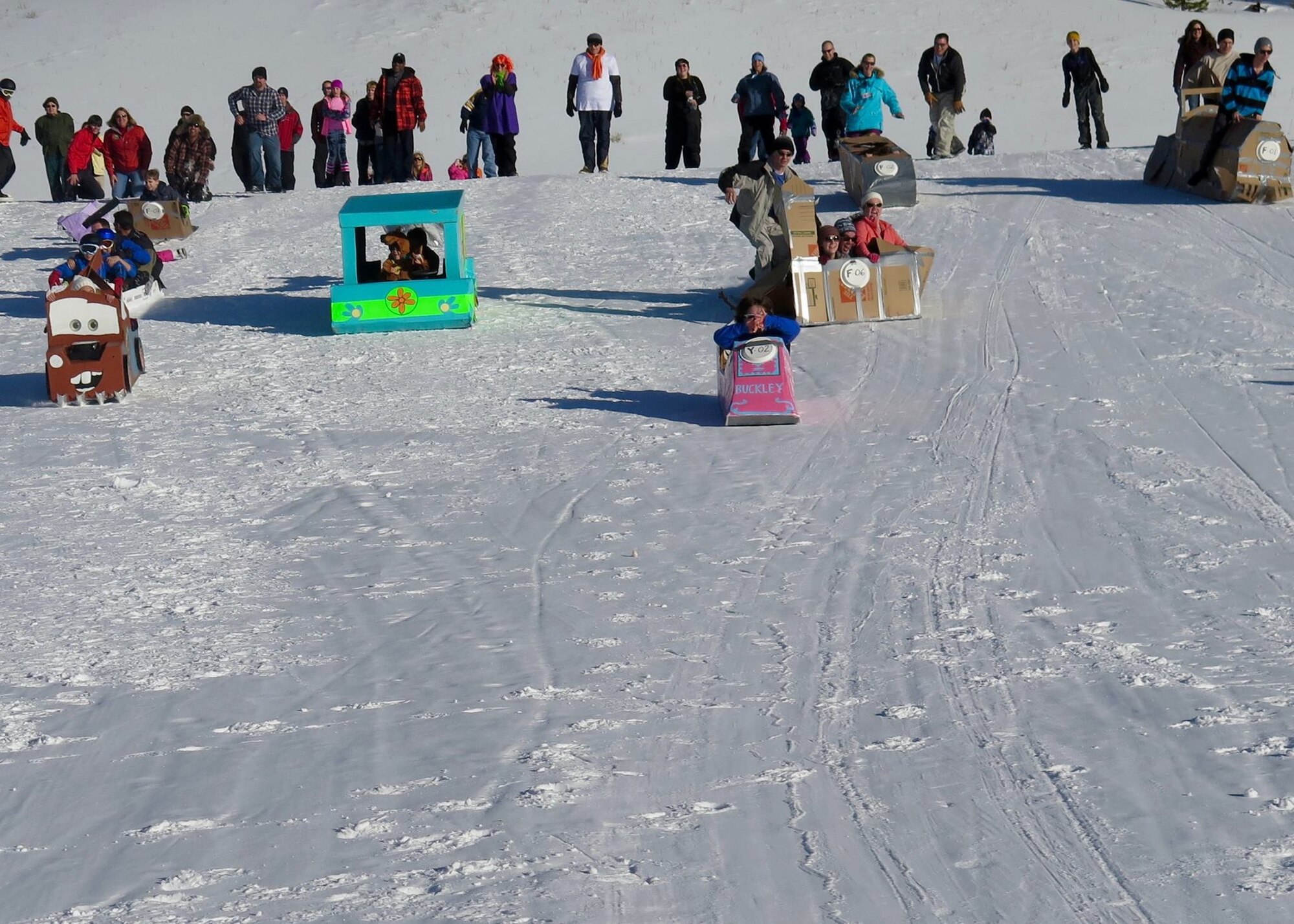 Participants taking part in a cardboard race at Keystone Resort during SnoFest 2016