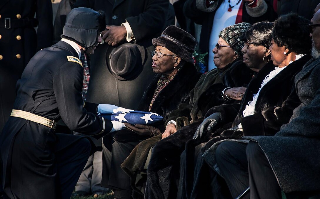 Army Capt. Craig Morin presents an American flag to 2nd Lt. Samuel G. Leftenant's eldest sister, Nancy Leftenant-Colon, during a full military honors memorial service held for Leftenant at Arlington National Cemetery, January 14, 2016, in Arlington, Virginia.

A U.S. Army fighter pilot, and one of the famed African American Tuskegee Airmen, Samuel G. Leftenant, 21, was involved in a midair collision while escorting bombers to Sankt Viet, Austria, causing him to bailout of his damaged aircraft. He was reported MIA on April 12, 1945 and declared dead in 1946, since he was never found. Leftenant-Colon, from East Norwich, N.Y., was a nurse with the Army Reserves. She was stationed with the Tuskegee Airmen in Columbus, Ohio, after her brother died, and worked there until 1949. (U.S. Army photo by Cynthia Mitchell, U.S. Army Corps of Engineers, Baltimore District)