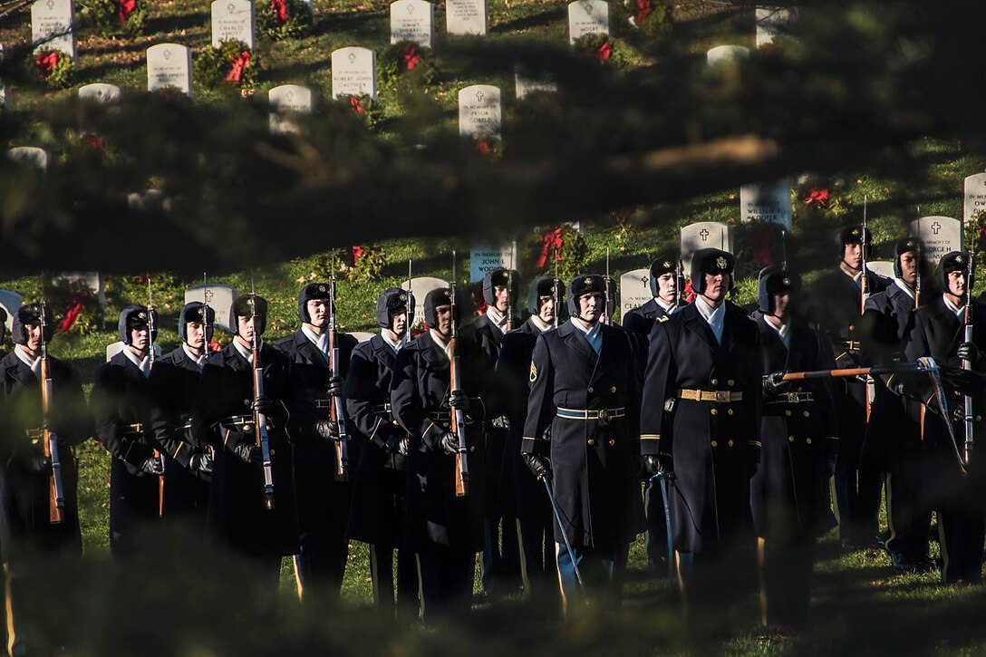 Members of the honor guard await the Caisson Platoon during the full military honors memorial service held for 2nd Lt. Samuel G. Leftenant at Arlington National Cemetery, Jan. 14, 2016, in Arlington, Va. A U.S. Army fighter pilot, and one of the famed African American Tuskegee Airmen, Samuel G. Leftenant, 21, was involved in a midair collision while escorting bombers to Sankt Viet, Austria, causing him to bailout of his damaged aircraft. He was reported MIA on April 12, 1945, and declared dead in 1946, since he was never found. (U.S. Army photo by Cynthia Mitchell, U.S. Army Corps of Engineers, Baltimore District)