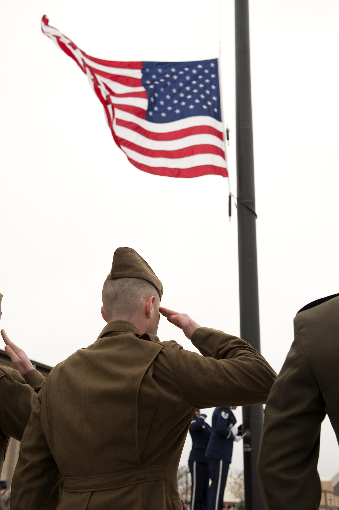 Goodfelllow Air Force Base Honor Guard members dressed in 1940 Army Air Corps uniforms salute the U.S. flag during the 75th Diamond Anniversary flag-raising reenactment at the Norma Brown building on Goodfellow Air Force Base, Texas, Jan. 26, 2016. Members of the guard and various volunteers dressed in historical uniforms in remembrance of the original flag-raising on Jan. 26, 1941. (U.S. Air Force photo by Airman 1st Caelynn Ferguson/Released)