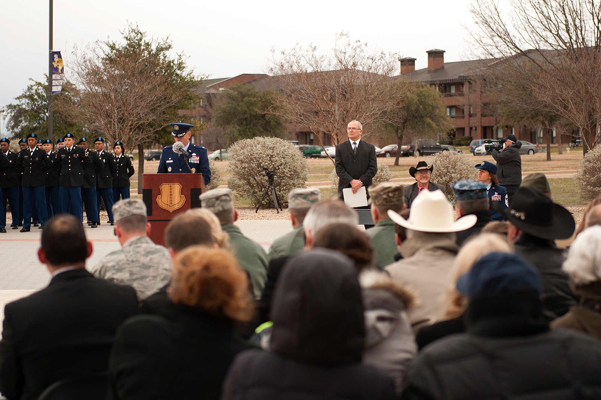 U.S. Air Force Col. Michael L. Downs, 17th Training Wing Commander, gives a speech during the 75th Diamond Anniversary flag raising reenactment at the Norma Brown building on Goodfellow Air Force Base, Texas, Jan. 26, 2016. The flag raising reenactment featured a Vultee BT-15 Valiant flyover and Rockwell B-1 Lancer flyover during the ceremony. (U.S. Air Force photo by Airman 1st Class Caelynn Ferguson/Released)