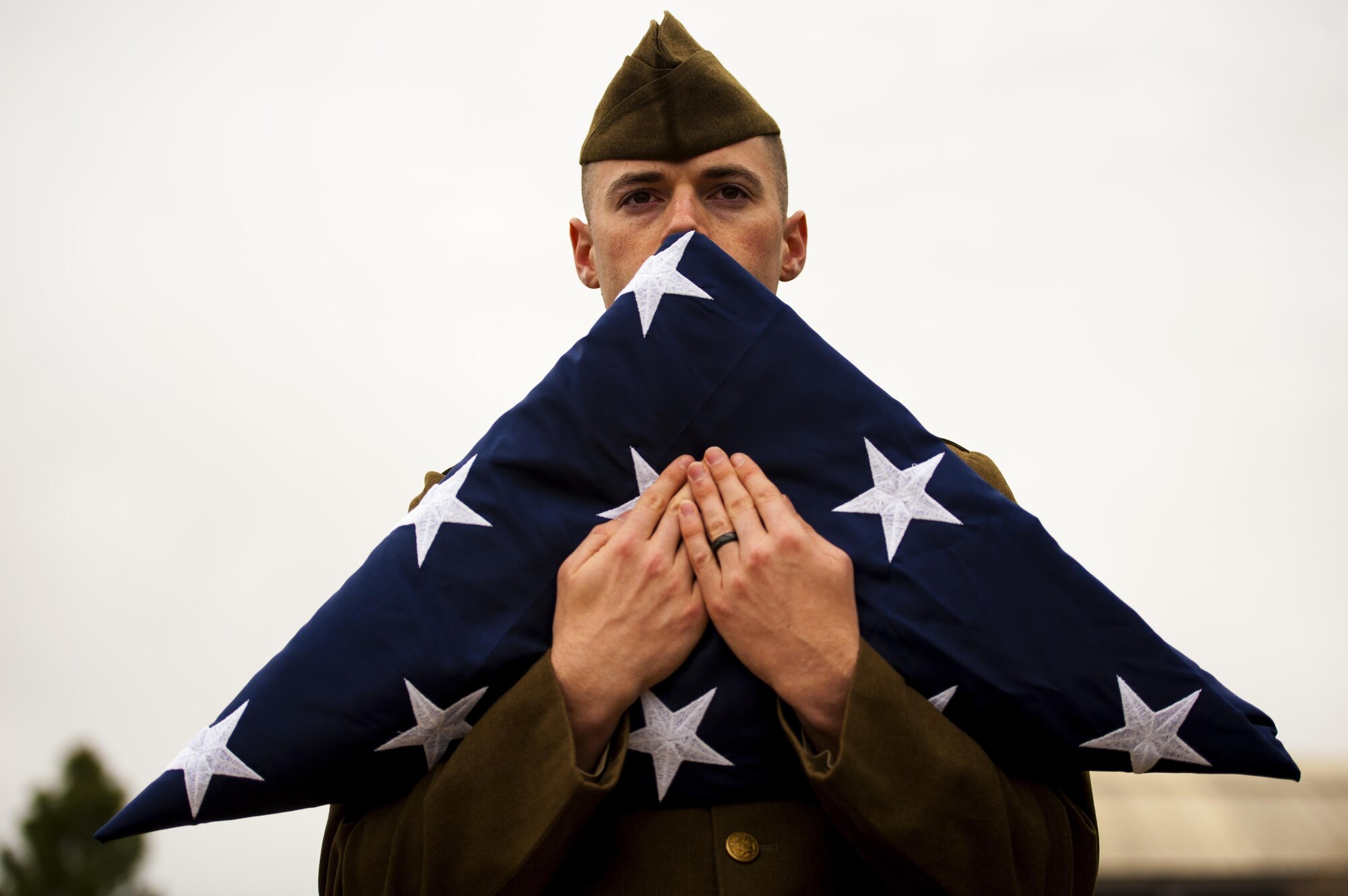 U.S. Air Force Senior Airman Austin T. Gregg, 17th Medical Support Squadron medical information systems technician, holds the American flag during the 75th Diamond Anniversary at the Norma Brown building on Goodfellow Air Force Base, Texas, Jan. 26, 2016. Honor guard members, dressed in uniforms from the 1940s, passed off the flag to a contemporary fitted honor guard to honor all generations of Goodfellow. (U.S. Air Force photo by Senior Airman Scott Jackson/Released)