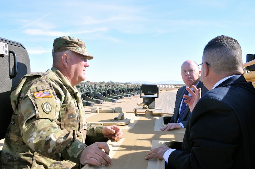 James Balocki (center), command executive officer, Office of the Chief of Army Reserve, and Maj. Gen. Nickolas Tooliatos, commanding general, 63rd Regional Support Command, listen as Hugo Gonzales (right), director of logistics, 63rd RSC, briefs Balocki on assets owned by the 63rd RSC at Equipment Concentration Site 171, Yermo, Calif., Jan. 25. Balocki toured multiple 63rd RSC facilities dispersed across four states, Jan. 22-26. The tour was comprised of visiting Area Maintenance Support Activity, Equipment Concentration Sites and Reserve Personnel Action Centers in Texas, New Mexico, Nevada and California, as Balocki met 63rd RSC personnel to find out what needs and improvements can be made to enhance their workplaces.