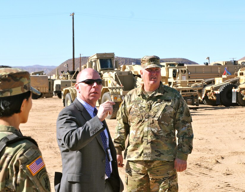 James Balocki (center), command executive officer, Office of the Chief of Army Reserve, makes observations on vehicles at Equipment Concentration Site 171, Yermo, Calif., Jan. 25, as Maj. Gen. Nickolas Tooliatos, commanding general, 63rd Regional Support Command, looks on. ECS 171 was one of Balocki’s stops on a tour of 63rd RSC facilities in Texas, New Mexico, Nevada and California, Jan. 22-26, as Balocki met 63rd RSC personnel to find out what needs and improvements can be made to enhance their workplaces.