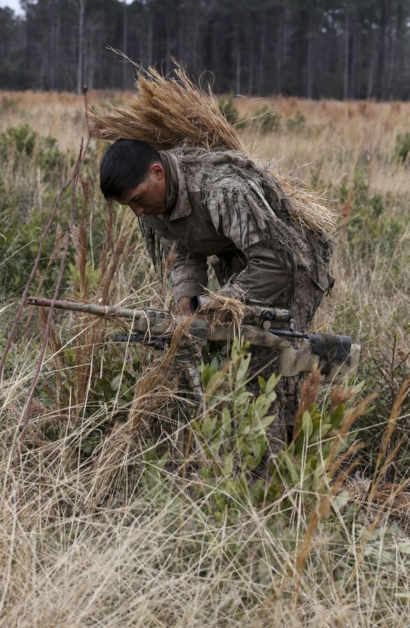 Corporal Brighten Bell, a student undergoing the 2nd Marine Division Combat Skills Center Pre-Scout Sniper Course, prepares to move during a stalking exercise at Camp Lejeune, N.C., Jan. 22, 2016. The DCSC offers several infantry-based courses to enhance the combat readiness of its Marines. (U.S. Marine Corps photo by Cpl. Paul S. Martinez/Released)