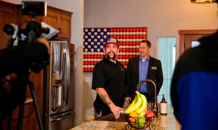 Sgt. Nick Kimmel surveys the kitchen of his new Smart Home after his dedication ceremony organized by the Gary Sinise Foundation takes place Jan. 6, in Fallbrook, Calif. With the support of multiple foundations, programs and contractors, Kimmel was presented a “Smart Home” that provides comfort, security, energy efficiency and convenience to the home owner by being accessible via mobile devices such as computers, phones and tablets. Kimmel, a native of Moses Lake, Wash., was a combat engineer with 9th Engineer Support Battalion in Okinawa, Japan. On Dec. 1, 2011, during Kimmel’s deployment in Afghanistan, he jumped from a forklift onto a 40-pound Improvised Explosive Device, losing both legs and his left arm. (Marine Corps photo by Pvt. Robert Bliss/Released)