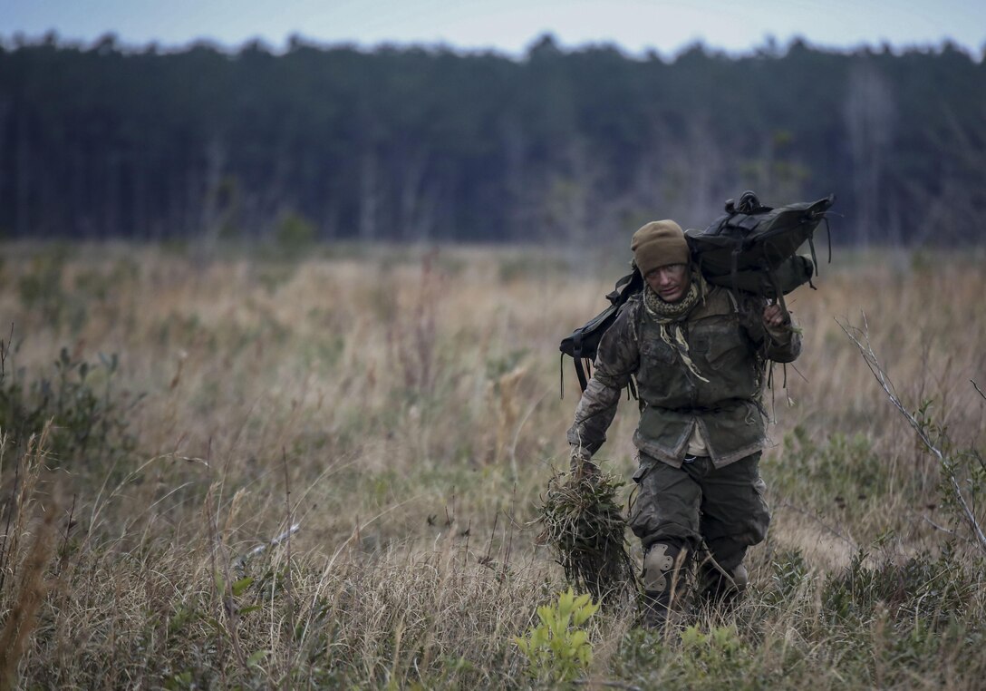 A Marine student undergoing the 2nd Marine Division Combat Skills Center’s Pre-Scout Sniper Course departs a field following a stalking exercise at Camp Lejeune, N.C., Jan. 22, 2016. The DCSC offers several infantry-based courses to enhance the combat readiness of its Marines.  (U.S. Marine Corps photo by Cpl. Paul S. Martinez/Released)