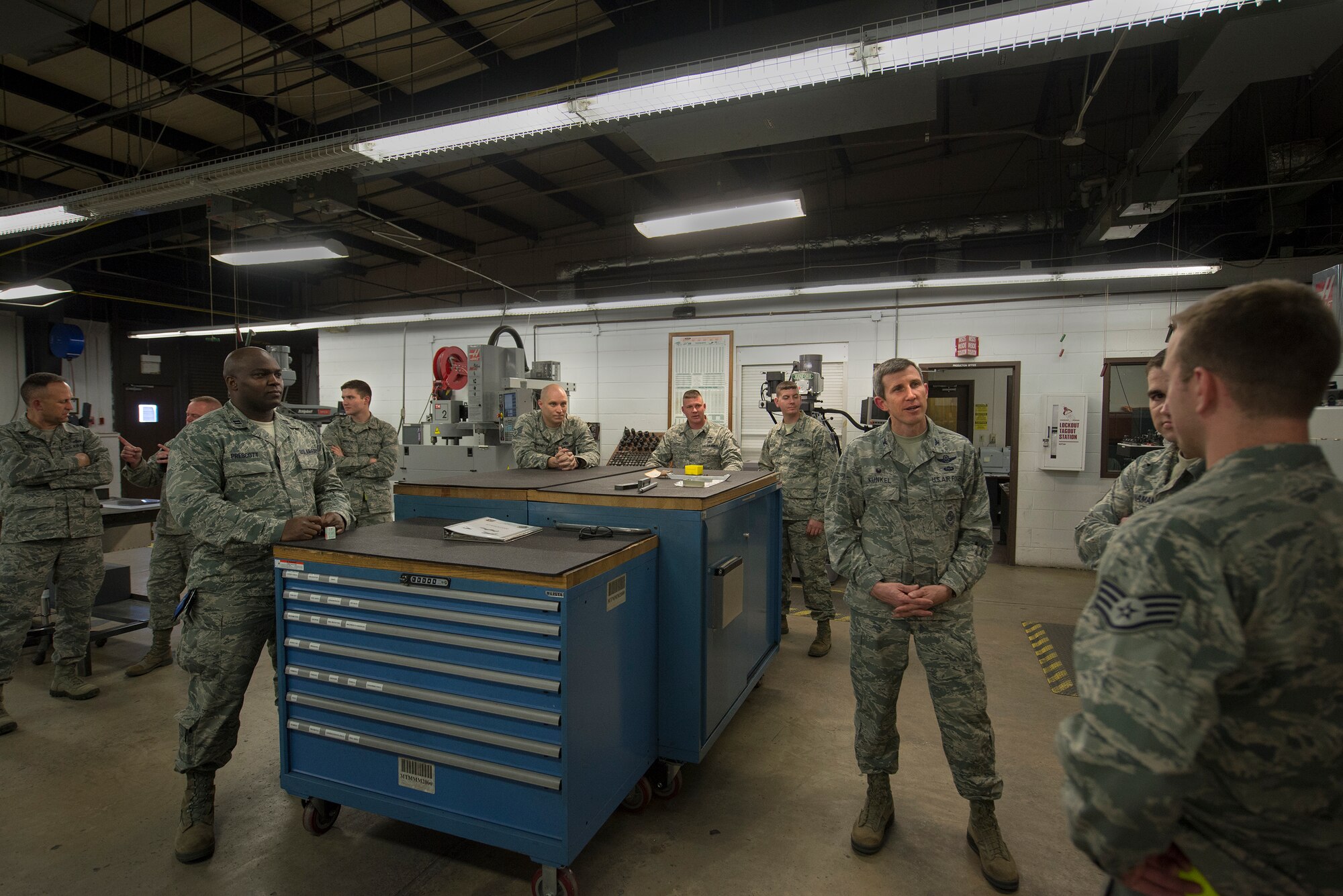 The 23d Equipment Maintenance Squadron aircraft metals technology flight explains their mission to U.S. Air Force Col. Thomas Kunkel, 23d Wing commander, second from right, after a water jet machining center demonstration Jan. 25, 2016, at Moody Air Force Base, Ga. During the demonstration, the machine blasted a mixture of water and garnet sand to cut a piece of scrap metal. (U.S. Air Force photo by Airman Daniel Snider/Released)
