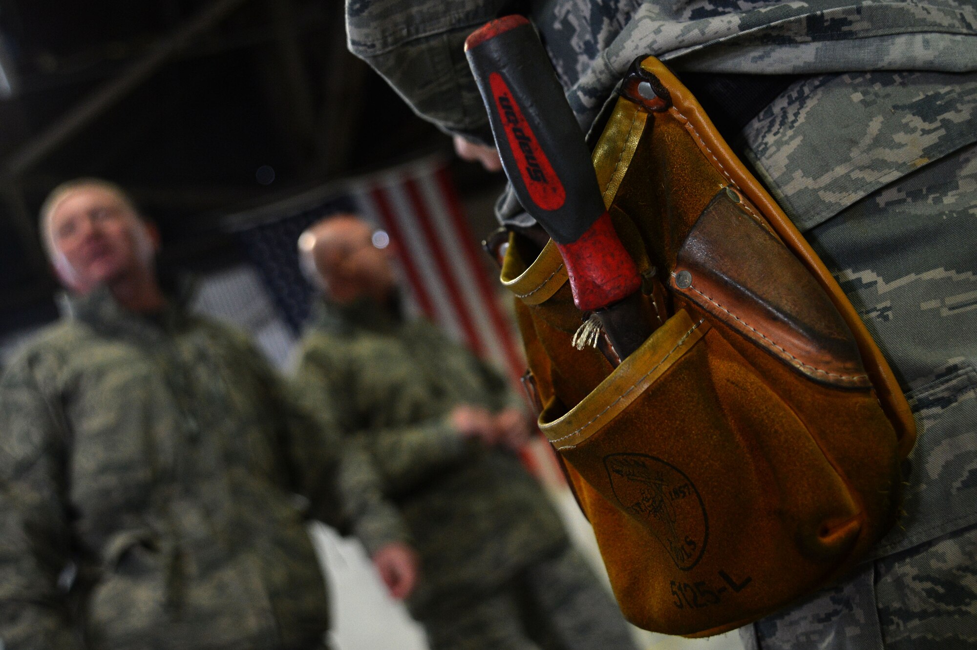 Tools hang on the waist of a U.S. Airman during a Load Crew of the Year competition at Shaw Air Force Base, S.C., Jan. 22, 2016. Throughout the competition, Airmen assigned to the load crews units came out and cheered on their team as they raced to load munitions. (U.S. Air Force photo by Senior Airman Michael Cossaboom)