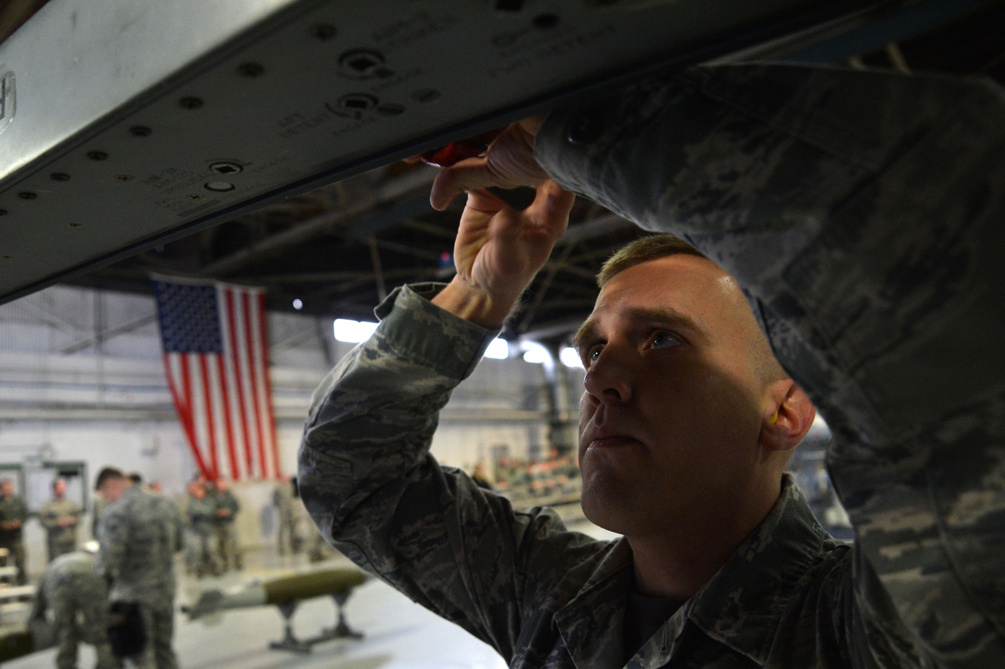 U.S. Air Force Senior Airman Anthony Howell, 20th Equipment Maintenance Squadron load crew member, tightens a bolt on an F-16CM Fighting Falcon during a Load Crew of the Year competition at Shaw Air Force Base, S.C., Jan. 22, 2016. The competition pits load crew teams against each other, testing their teamwork and their unit’s comradery (U.S. Air Force photo by Senior Airman Michael Cossaboom)