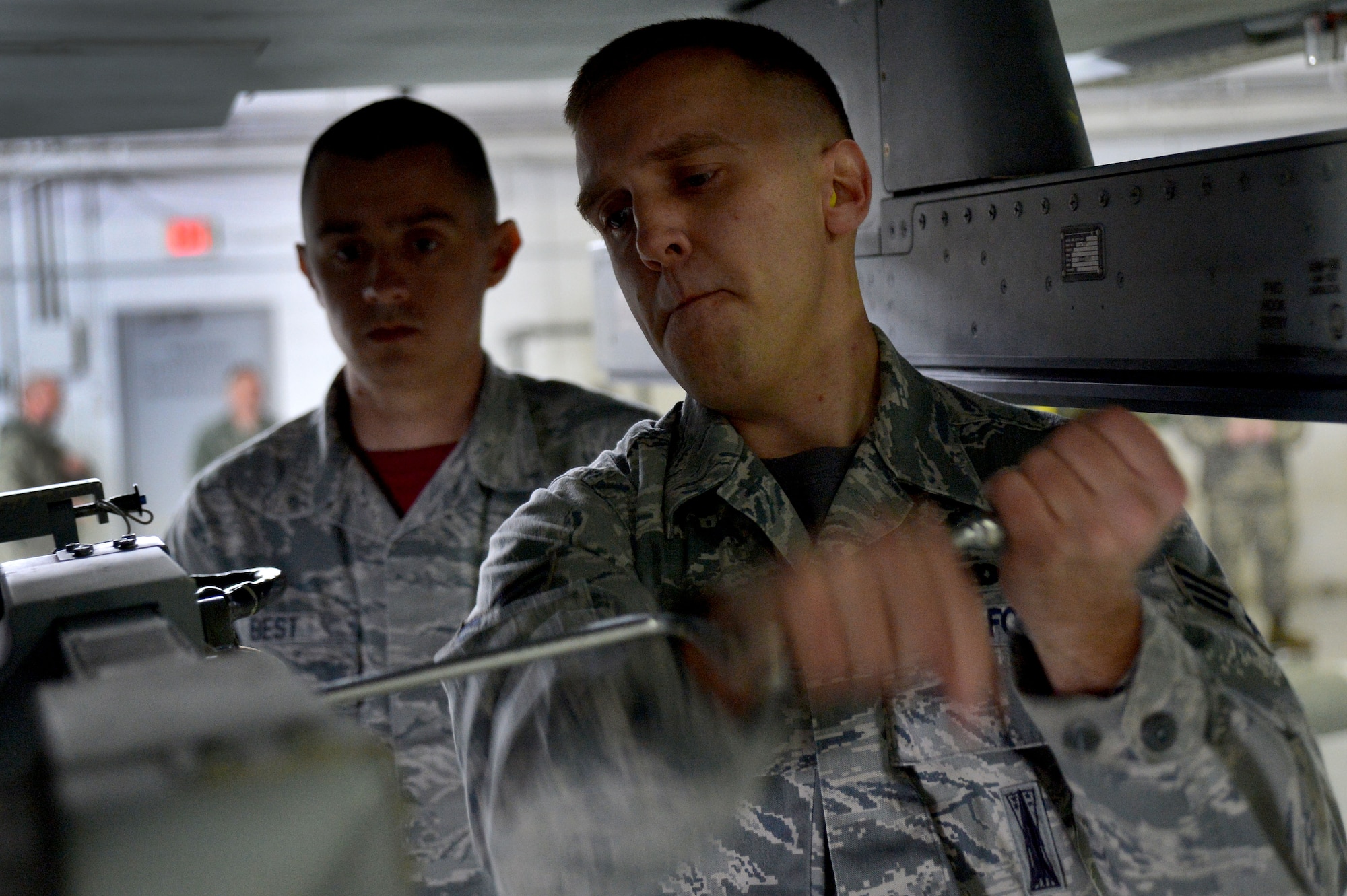 U.S. Air Force Senior Airman Anthony Howell, 20th Equipment Maintenance Squadron load crew member, tightens a bolt on an F-16CM Fighting Falcon during a Load Crew of the Year competition at Shaw Air Force Base, S.C., Jan. 22, 2016. The competition pits load crew teams against each other testing their teamwork and their unit’s comradery. (U.S. Air Force photo by Senior Airman Michael Cossaboom)