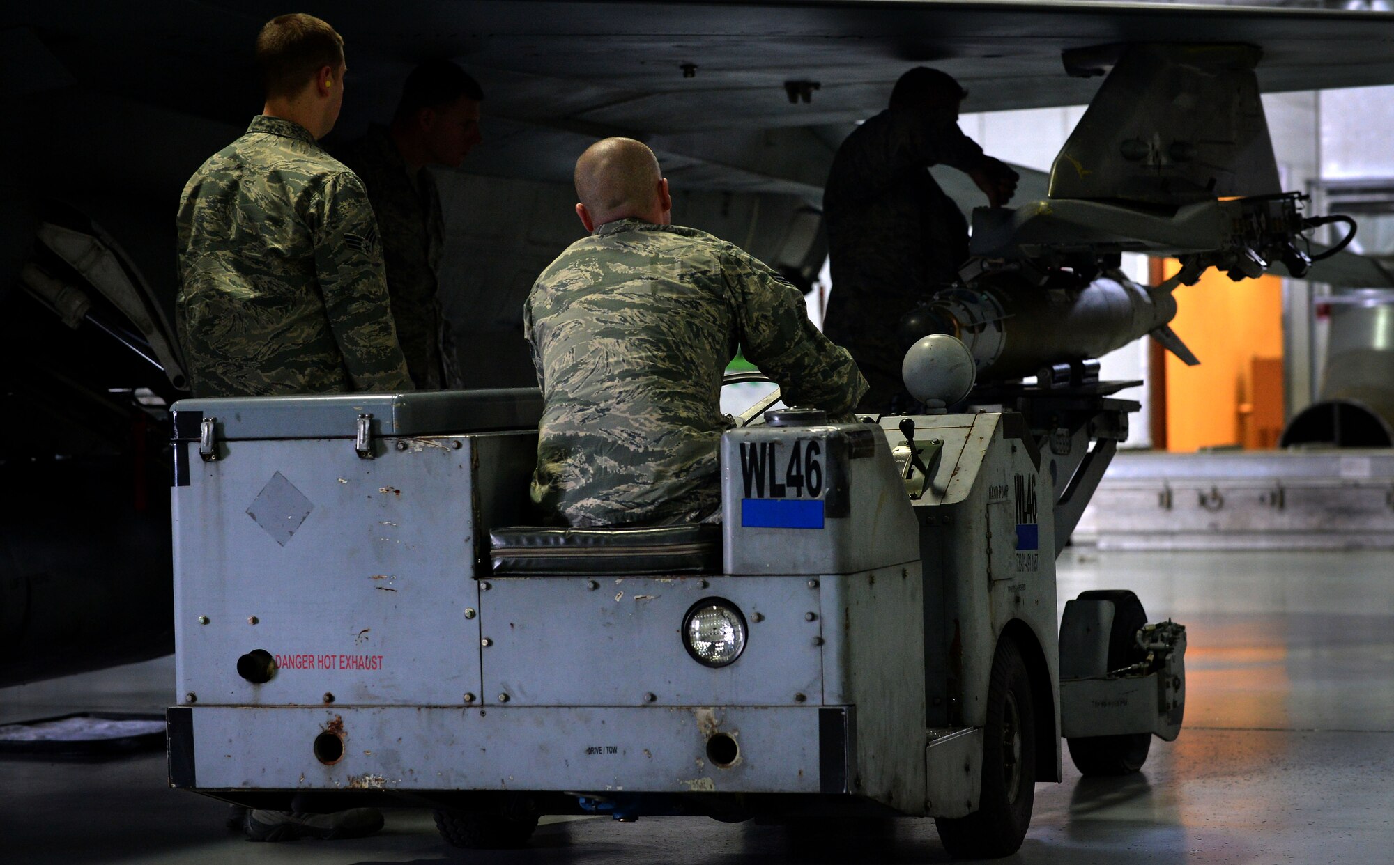 U.S. Airmen assigned to the 20th Equipment Maintenance Squadron load munitions onto an F-16CM Fighting Falcon during a Load Crew of the Year Competition at Shaw Air Force Base, S.C., Jan. 22, 2016. The teams worked together to load three munitions as fast and safe as they could. (U.S. Air Force photo by Senior Airman Michael Cossaboom)