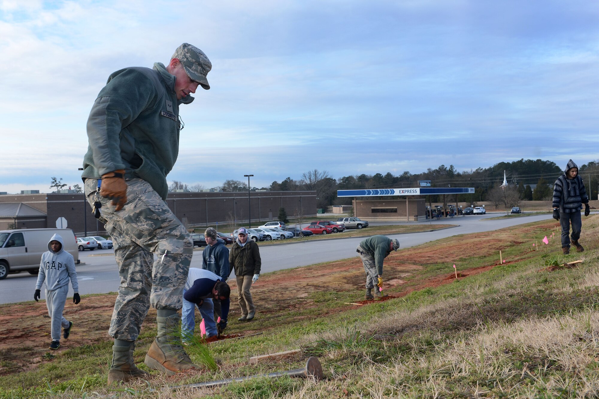 U.S. Air Force Airman 1st Class Brandon Duquette, 20th Civil Engineering Squadron pavement and construction equipment apprentice, plants a longleaf pine sapling at Shaw Air Force Base, S.C., Jan. 21, 2016. More than 20 Team Shaw volunteers and 14 Boy and Cub Scouts planted approximately 500 longleaf pine saplings around Shaw as part of an ongoing beautification and ecological restoration  project supported jointly by the 20th Fighter Wing and the Sumter community. (U.S. Air Force photos by Senior Airman Zade Vadnais)