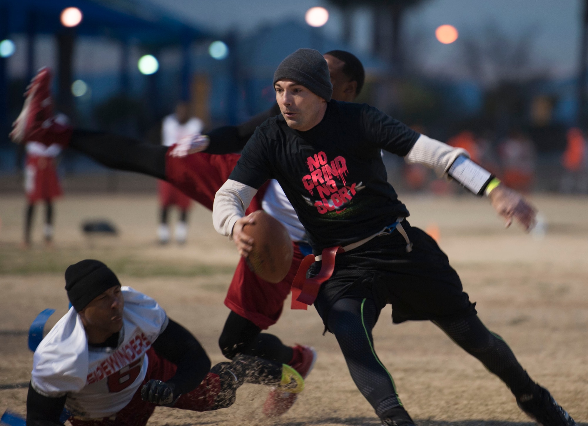 Staff Sgt. Justin Miller, 823rd Maintenance Squadron, runs with the football during a flag football tournament at Tropical Breeze Park in North Las Vegas on Jan. 16, 2016. This tournament marked the first time the Nellis Air Force Base flag football team played in a national tournament. (U.S. Air Force photo by Senior Airman Mikaley Kline)