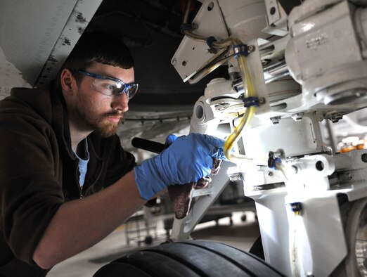David Garretson, a second year student at Iowa Western Community College, performs a general lubrication of the zerks on the nose strut of the nose wheel in the Bennie Davis Maintenance Facility at Offutt Air Force Base, Neb., Jan. 25, 2016. Garretson is one of three students from IWCC who have been chosen to intern with the 55th Maintenance Squadron, providing valuable experience and a gateway to Department of Defense jobs upon graduation. (U.S. Air Force photo/Senior Airman Rachel Hammes)