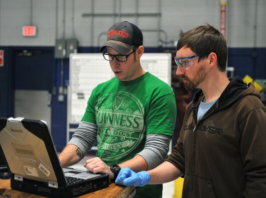 Zach Bezold, left, a maintainer with the 55th Maintenance Squadron, studies operating instructions with David Garretson, a student at Iowa Western Community College, in the Bennie Davis Maintenance Facility at Offutt Air Force Base, Neb., Jan. 25, 2016. Garretson is interning with the squadron to gain valuable on-the-job training. (U.S. Air Force photo/Senior Airman Rachel Hammes)
