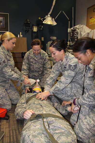 Senior Airman Katherine Jarvis, Senior Airman Melinda Johnson, Staff Sgt. Brittany Noll, and Senior Airman Brittany Ralston perform a rapid trauma assessment as part of the EMT refresher training held at Pittsburgh International Airport Air Reserve Station, Jan. 11-15, 2016.
     Nineteen medical technicians from the 911th Aeromedical Staging Squadron, 911th Aeromedical Evacuation Squadron and 171st Air Refueling Wing Medical Group participated in the refresher training as part of the certification requirement by the National Registry for Emergency Medical Technicians. The certification is required every two years.  (U.S. Air Force photo by Master Sgt. Mark A. Winklosky)
