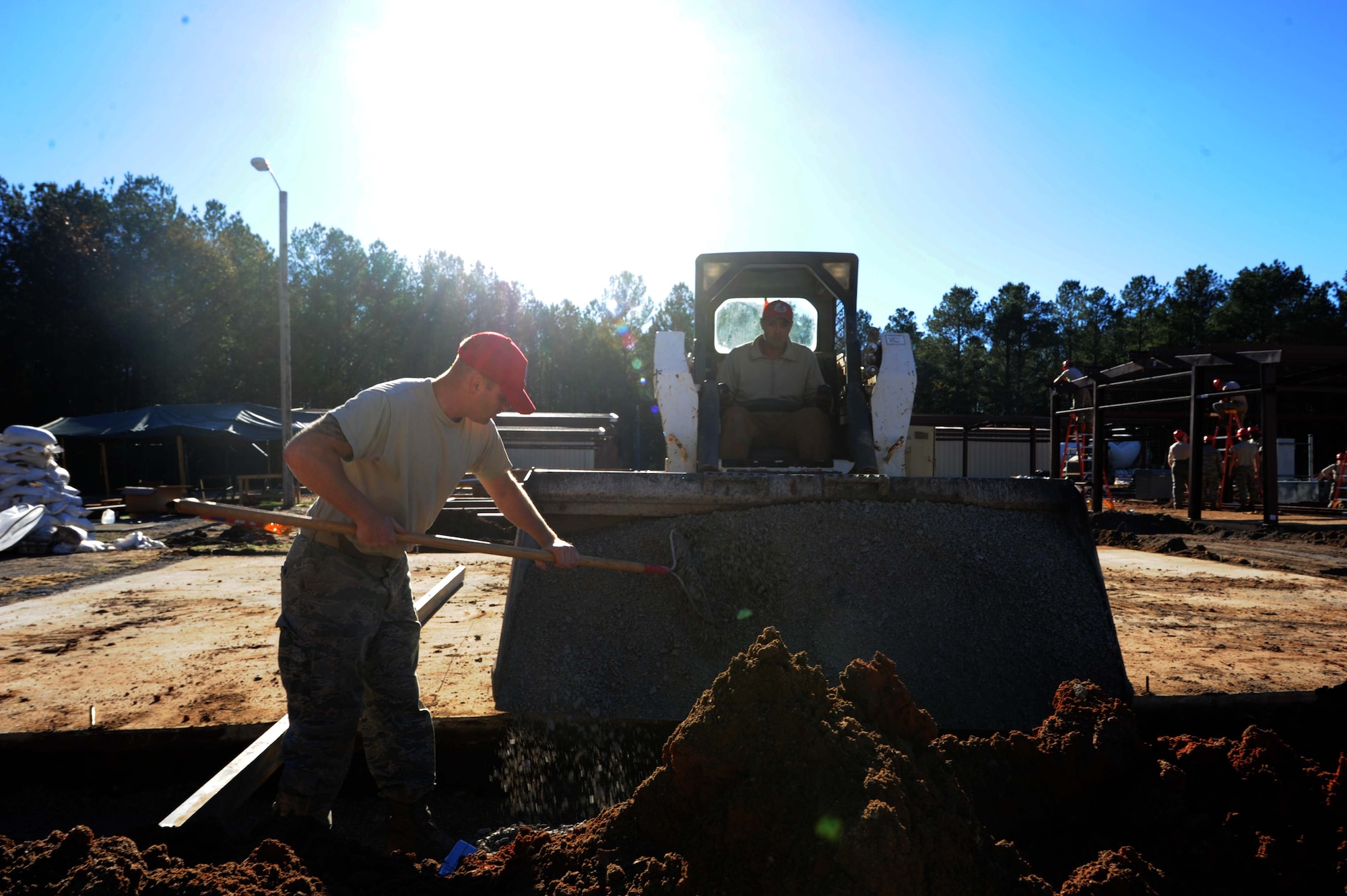 Airmen from the 823rd Rapid Engineer Deployable Heavy Operational Repair Squadron Engineer (RED HORSE) from Hurlburt Field, Florida, prepare a foundation footer for concrete at the Vigilant Warrior training site Dec. 15, 2015, near Titus, Alabama. RED HORSE is in the process of constructing a new latrine facility, K-Span buildings or arched steel panel buildings and lodging facilities. (U.S. Air Force photo by Airman 1st Class Alexa Culbert)