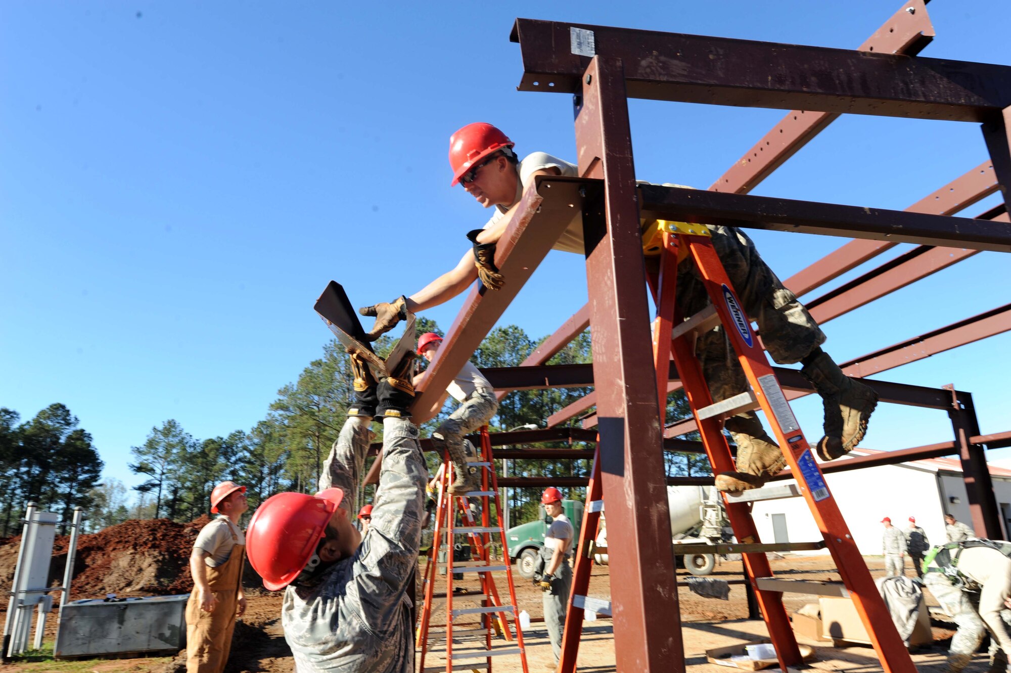 Airmen from the 823rd Rapid Engineer Deployable Heavy Operational Repair Squadron Engineer (RED HORSE) from Hurlburt Field, Florida, assemble the support beams for a pre-engineered building at the Vigilant Warrior training site Dec. 15, 2015, near Titus, Alabama. RED HORSE Squadrons travel base to base doing heavy construction projects for the Air Force.  (U.S. Air Force photo by Airman 1st Class Alexa Culbert)