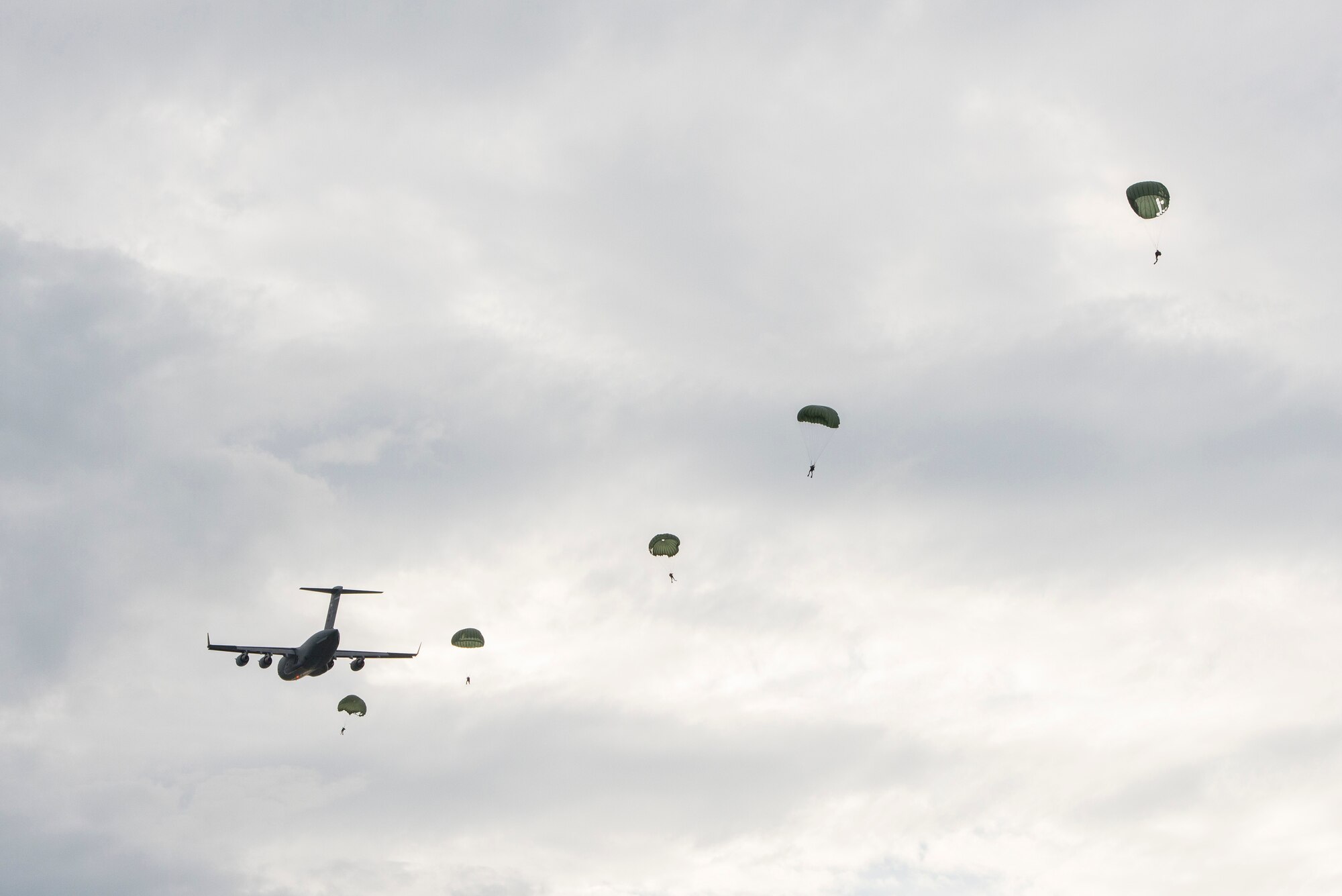 A C-17 Globemaster III from the Alaska Air National Guard’s 249th Airlift Squadron drops off paratroopers and equipment as part of an astronaut rescue exercise in the Atlantic Ocean near Cape Canaveral Air Force Station, Fla. Jan. 14. The 45th Operations Group Detachment 3 joined NASA's Commercial Crew Program and Air Force Reserve pararescuemen, combat rescue officers and survival, evasion, resistance and escape specialists to practice recovering astronauts quickly and safely in the event they would need to abort their spacecraft. The small Air Force detachment has served as the liaison between NASA’s Johnson Space Center in Houston, Texas, the Air Force and Department of Defense for more than 55 years training men and women of those organizations for launch contingencies and astronaut recovery. (U.S Air Force photo/Matthew Jurgens) (Released)