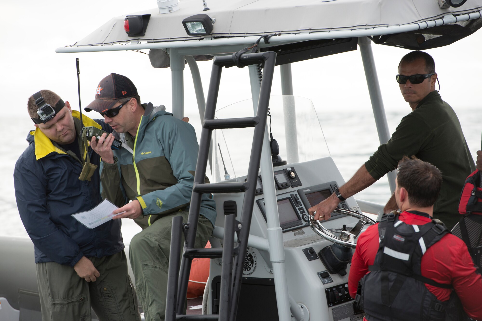 Cody Kelly, NASA Crew Survival Engineer, Dustin Gohmert, NASA Crew Survival Engineering Lead, and exercise participants test radio connectivity with a 45th Operations Group Detachment 3 Joint Space Operations Center from a vessel in the Atlantic Ocean during a NASA astronaut recovery exercise Jan. 14. Their goal was to verify radio transmission and reception distances between the airborne aircraft and the astronaut in the water. Det. 3, the Department of Defense's Human Space Flight Support Office, is the only Air Force staff that coordinates and trains personnel to support human spaceflight contingencies. Det. 3 supports all NASA human spaceflight missions, including Soyuz, Commercial Crew, and Orion, and consists of Air Force and Navy military and civilian personnel from a wide variety of specialties. (U.S Air Force photo/Matthew Jurgens)