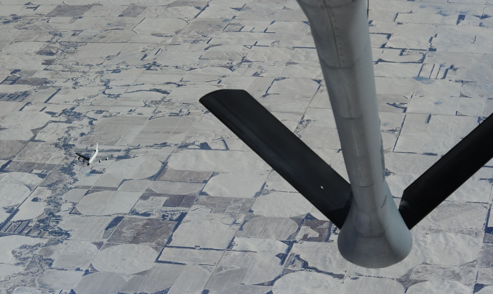 An RC-135V/W Rivet Joint reconnaissance aircraft leaves a KC-135 Stratotanker after aerial refueling training, Jan. 26, 2016, over Nebraska. According to the Air Force fact sheet, these aircraft support theater and national level consumers with near real time on-scene intelligence collection, analysis and dissemination capabilities. (U.S. Air Force photo/Senior Airman David Bernal Del Agua)