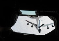 An RC-135V/W Rivet Joint reconnaissance aircraft approaches a KC-135 Stratotanker for aerial refueling training, Jan. 26, 2016, over Nebraska. These aircraft support theater and national level consumers with near real time on-scene intelligence collection, analysis and dissemination capabilities. (U.S. Air Force photo/Senior Airman David Bernal Del Agua)