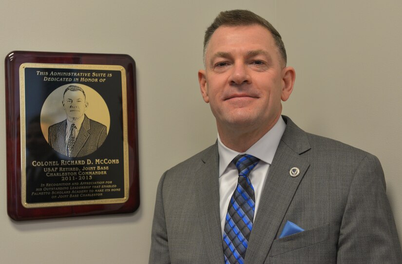 Colonel Richard McComb, former Joint Base Charleston commander, has a section of Palmetto Scholar’s Academy’s  new school building dedicated to him in Hunley Park at JB Charleston, S.C., on Jan. 23, 2016. McComb received a plaque to honor his efforts to get the new facility built.. (U.S. Air Force photo/Airman 1st Class Thomas T. Charlton)