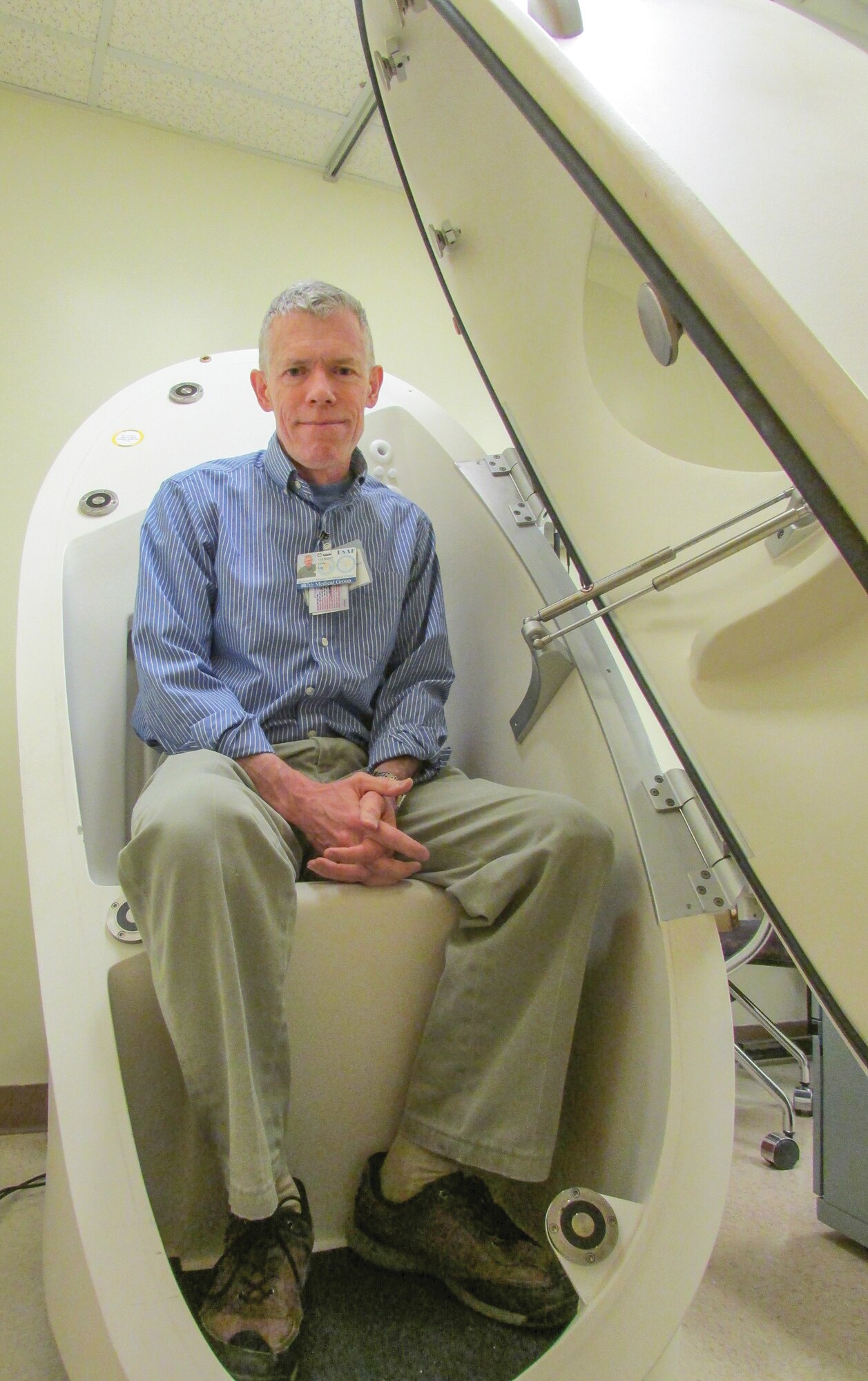 Guy Leahy, Kirtland’s new health promotions program coordinator, sits in the “Bod Pod,” which indicates where a person’s body fat level is and where it should be. Leahy can provide information on exercise, weight control, tobacco cessation, stress management, injury prevention and dietary supplements free to anyone affiliated with Kirtland. (Photo by Argen Duncan)