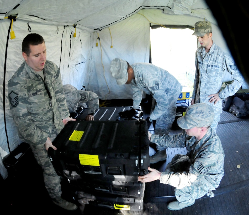 Members of the 113th Communications Flight, Joint Base Andrews, Md., connect communications packages for operational testing while deployed to Naval Air Station Joint Reserve Base New Orleans, La., for Exercise Sentry Voodoo 2016. The D.C. Air National Guard Airmen are participating in Joint Incident Site Communications Capability Training during the two-week exercise. (Air National Guard photo by Master Sgt. Craig Clapper/Released)